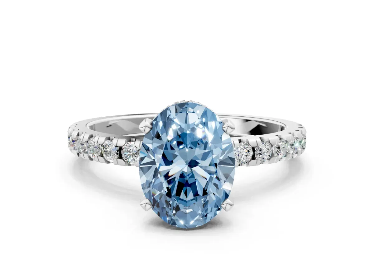 Fancy Blue Oval Cut Diamond Solitaire Ring with Round Pavé Band and Four-Prong Setting Silver