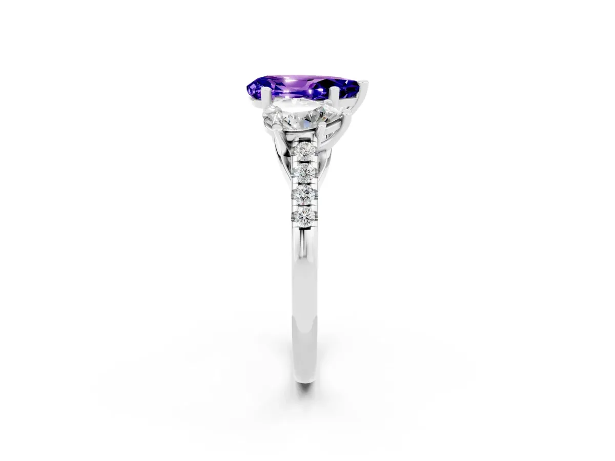Three-Stone Pear Cut Tanzanite Ring with Round Pavé Band and Prong Setting Platinum