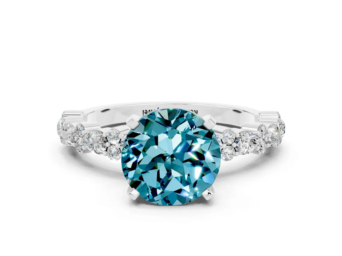 Round Cut Blue Topaz Side Stone Solitaire Ring with Round and Four-Prong Setting Silver