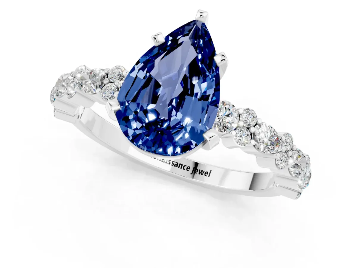 Pear Cut Blue Sapphire Side Stone Solitaire Ring with Round and Four-Prong Setting Silver