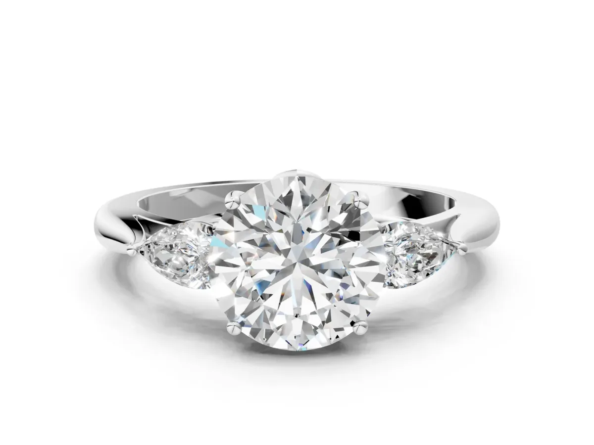 Three-Stone Round Cut Diamond Ring with Pear Side Stones in Four-Prong Setting Platinum