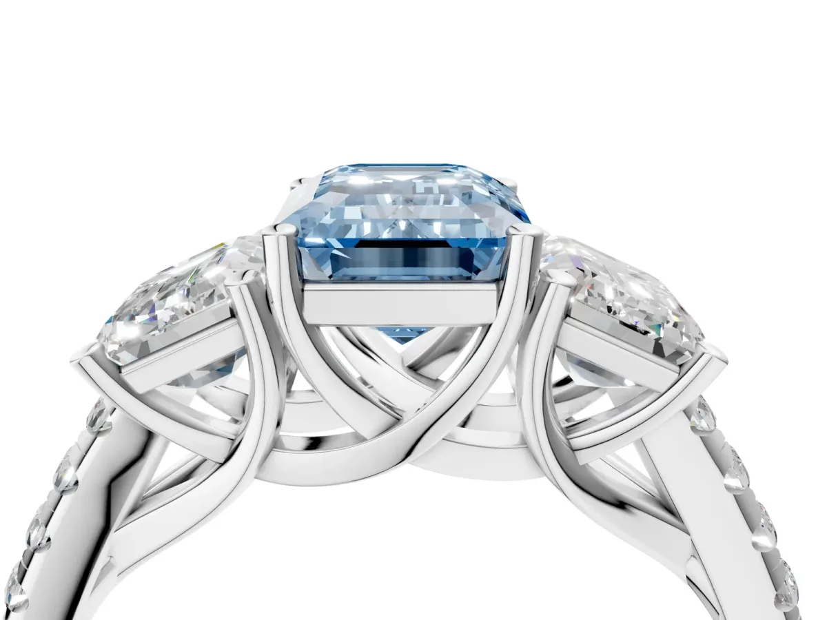 Fancy Blue Three-Stone Emerald Cut Diamond Ring with Round Pavé Band and Prong Setting Silver