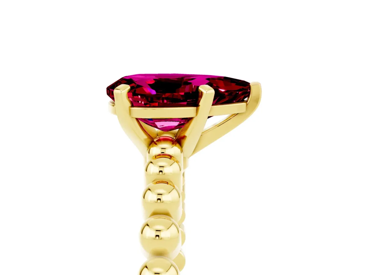 Pear Cut Garnet Solitaire Ring with Beaded Band and Prong Setting Yellow gold