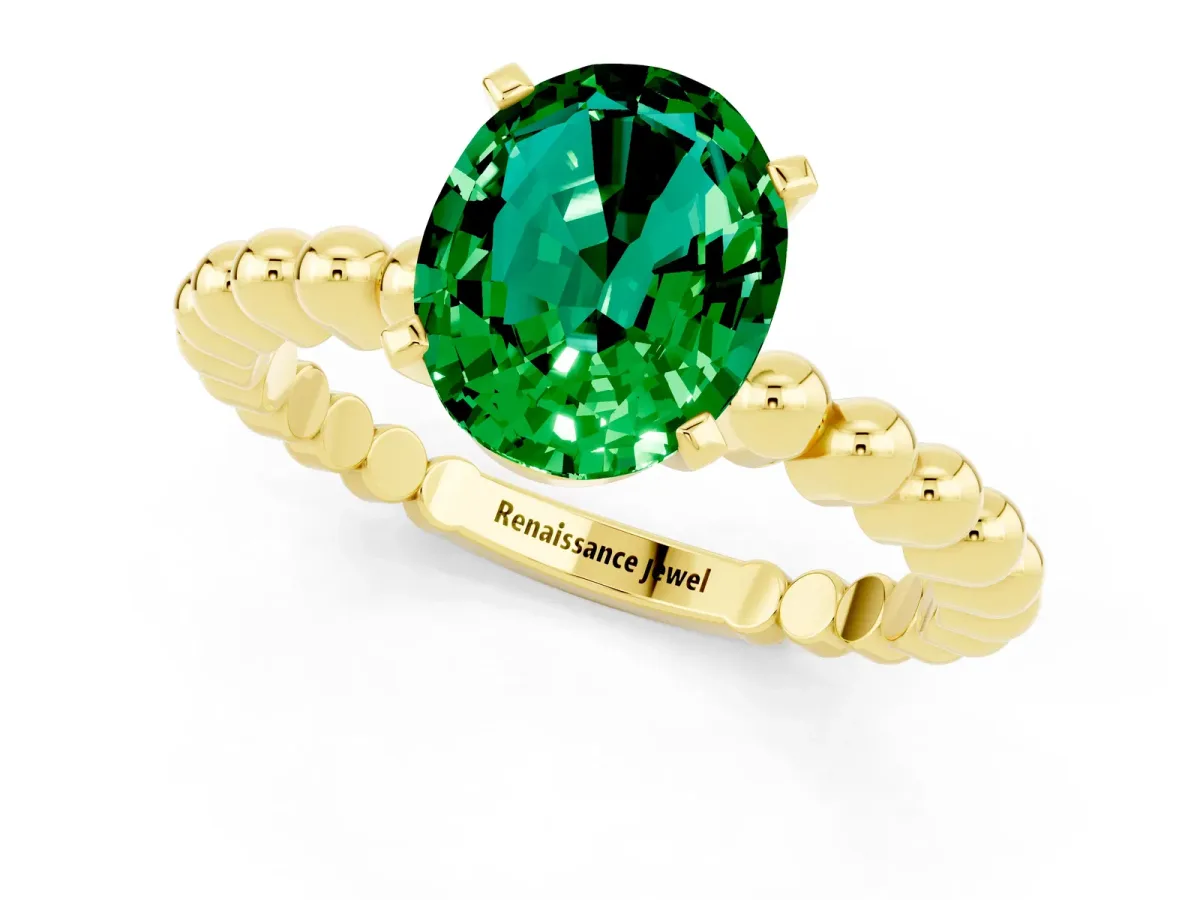 Oval Cut Emerald Solitaire Ring with Beaded Band and Prong Setting Yellow gold