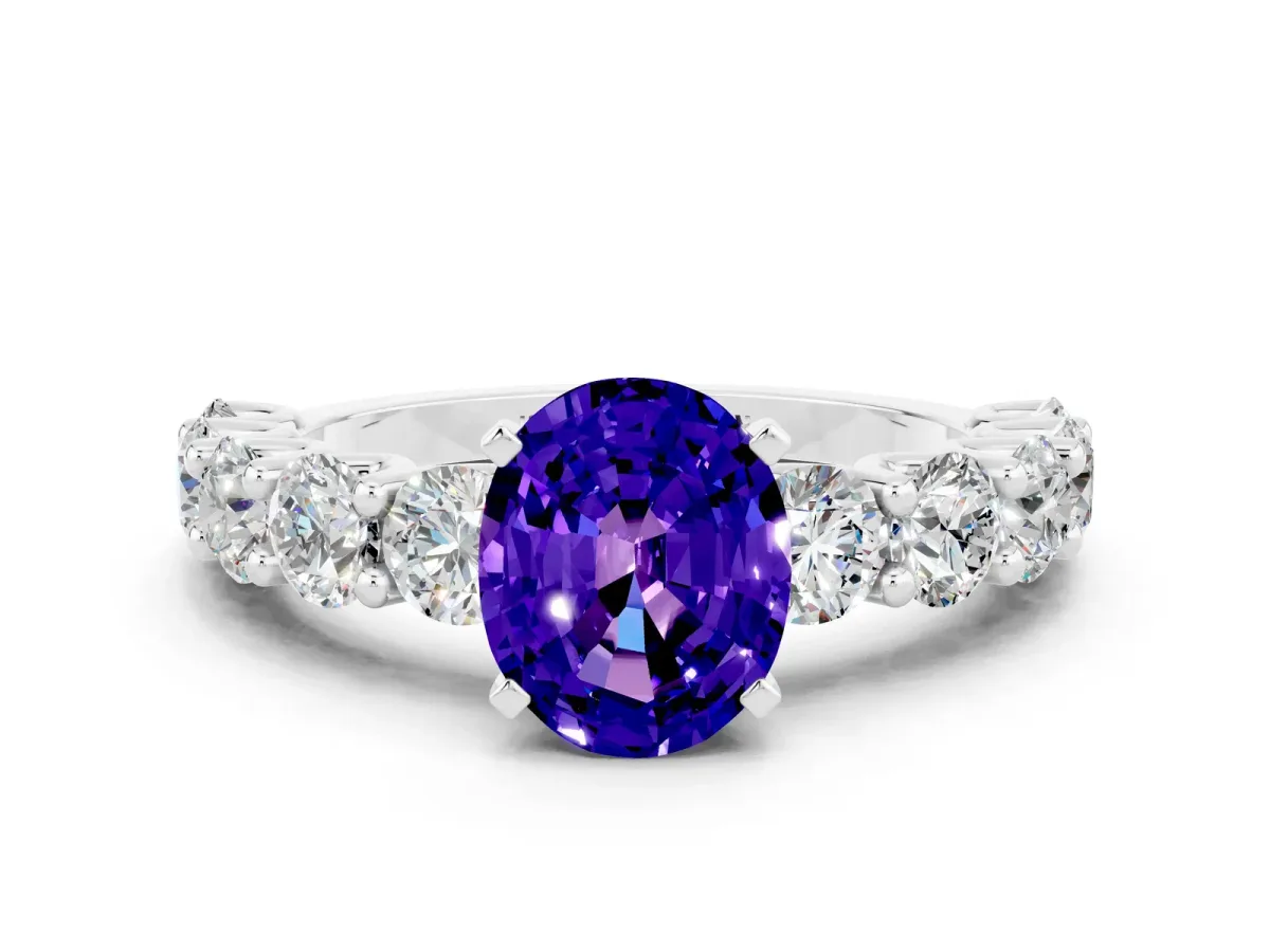 Oval Cut Tanzanite Prong Setting with Side Stones on a Pave Band Silver