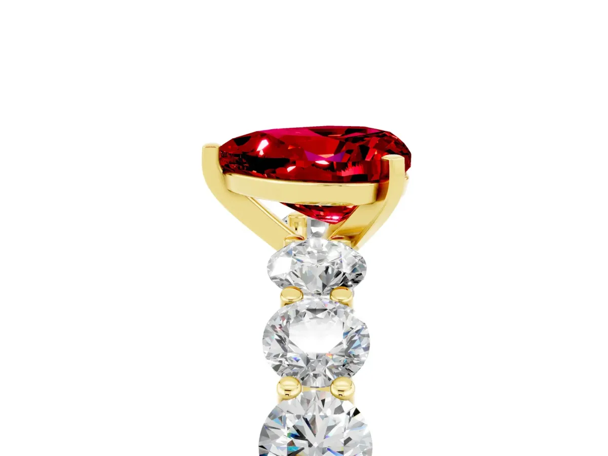 Heart Cut Ruby Prong Setting with Side Stones on a Pave Band Yellow gold