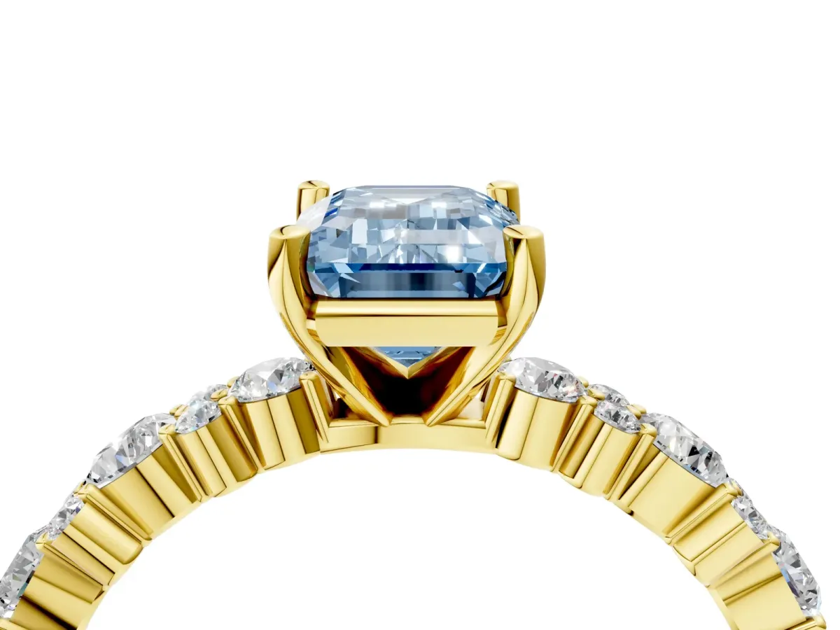 Fancy Blue Emerald Cut Diamond Side Stone Solitaire Ring with Round and Four-Prong Setting Yellow gold