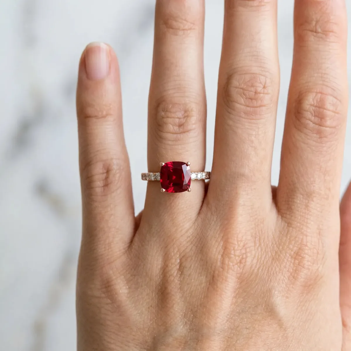 Cushion Cut Ruby Solitaire Ring with Round Pavé Band and Four-Prong Setting Rose gold