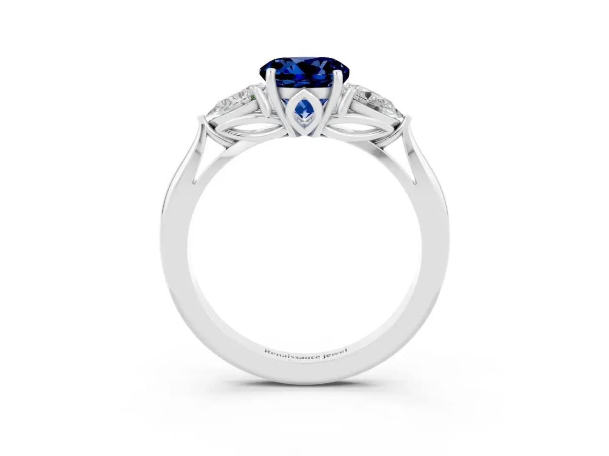 Three-Stone Round Cut Blue Sapphire Ring with Pear Side Stones in Four-Prong Setting Platinum