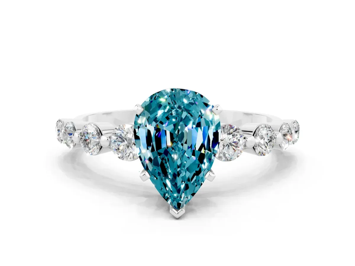 Pear Cut Solitaire Blue Topaz Ring with Pave Band and Four-Prong Setting Silver