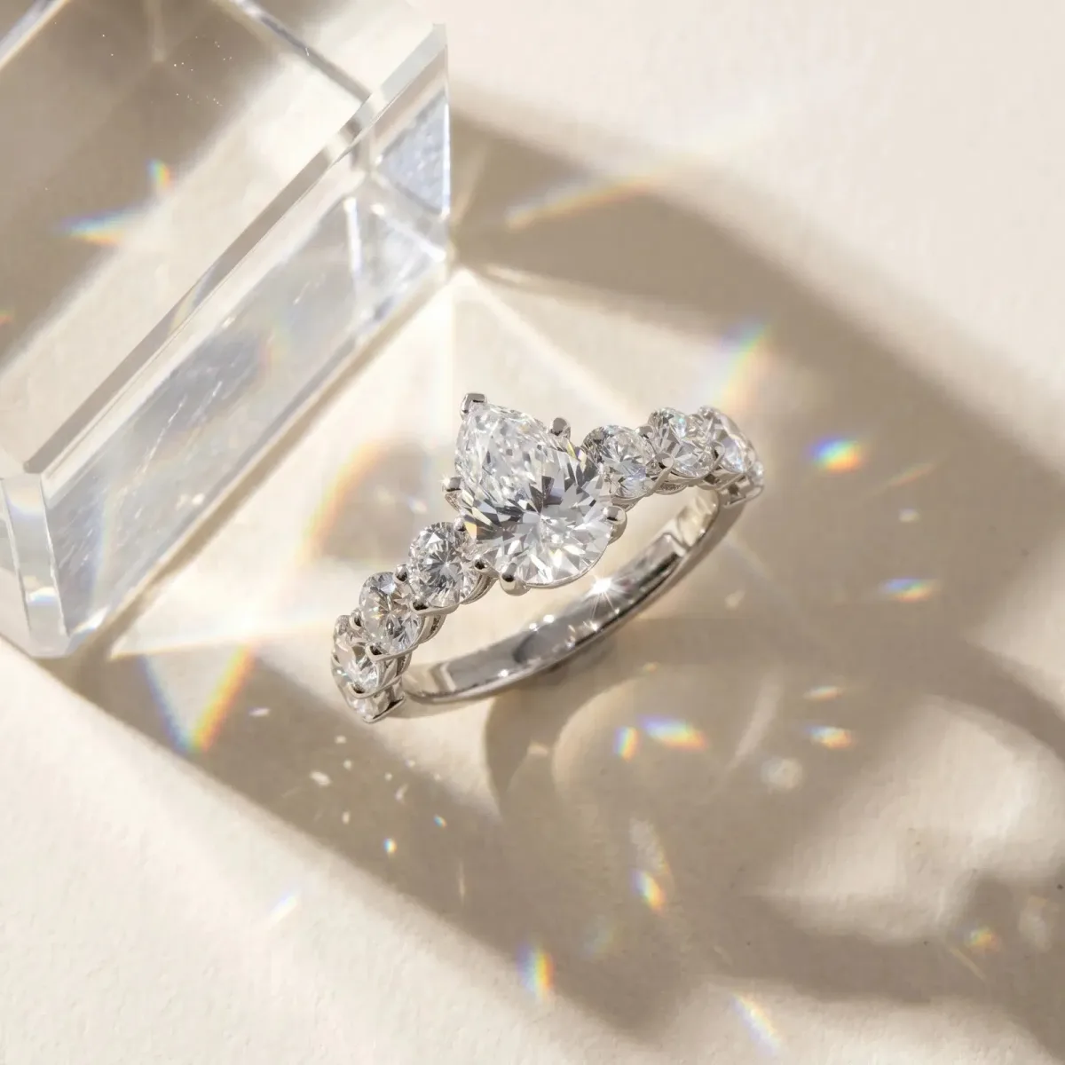 Pear Cut Diamond Prong Setting with Side Stones on a Pave Band Silver