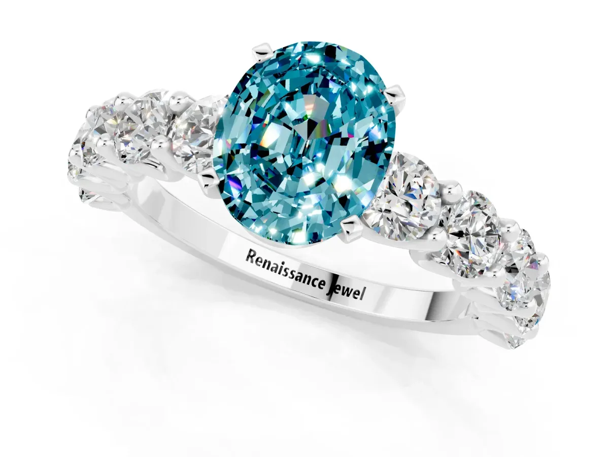 Oval Cut Blue Topaz Prong Setting with Side Stones on a Pave Band Silver