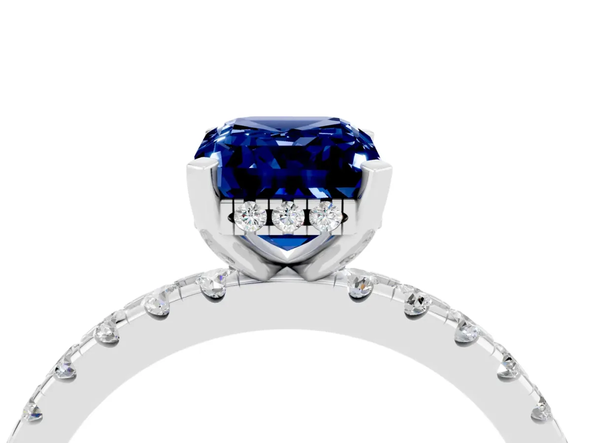 Emerald Cut Blue Sapphire Solitaire Ring with Round Pavé Band and Four-Prong Setting Silver