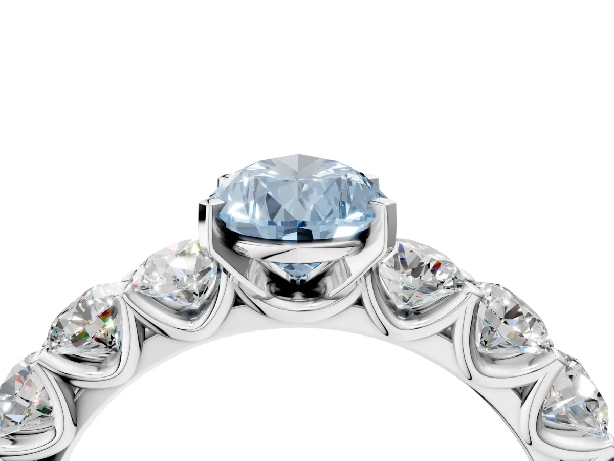 Fancy Blue Pear Cut Diamond Prong Setting with Side Stones on a Pave Band Platinum