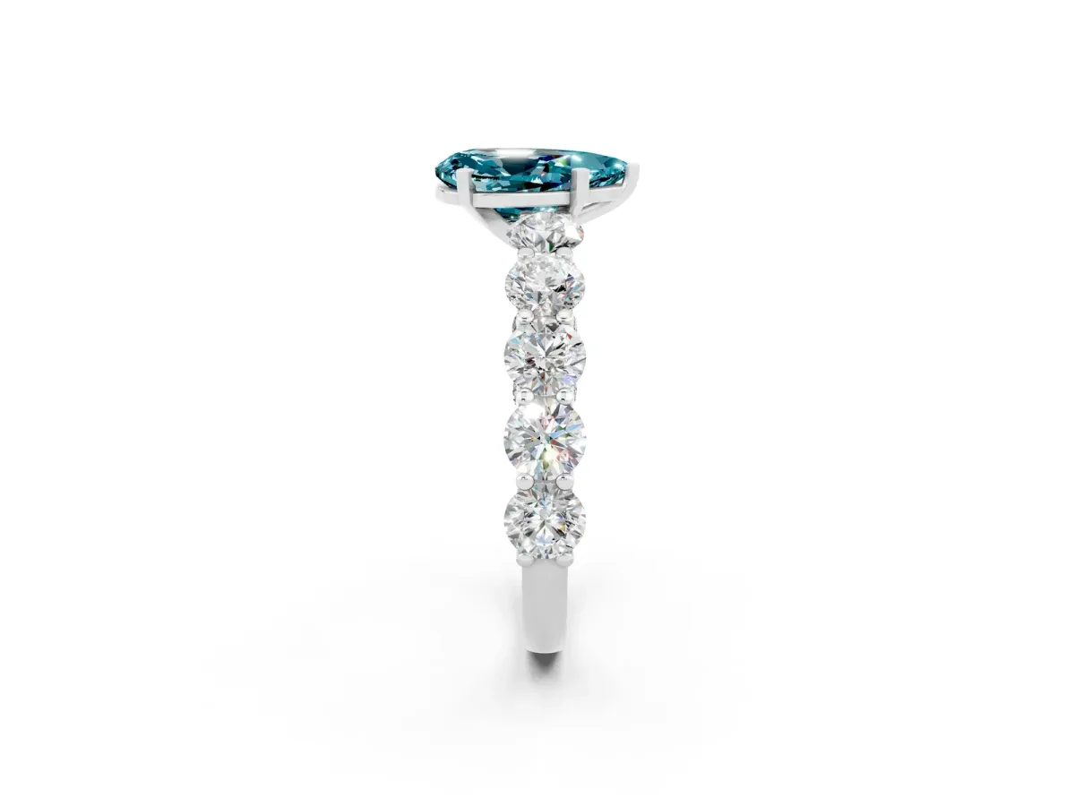 Pear Cut Blue Topaz Prong Setting with Side Stones on a Pave Band Silver