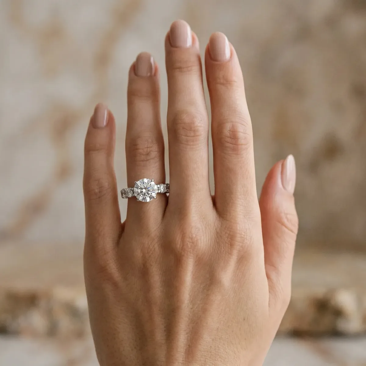 Round Cut Diamond Side Stone Engagement Ring with Four-Prong Setting Platinum