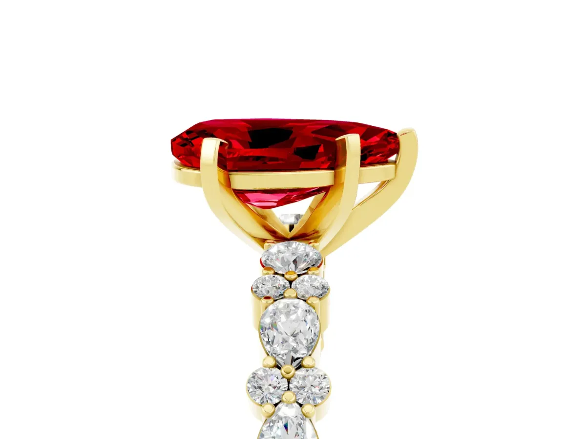 Pear Cut Ruby Side Stone Solitaire Ring with Round and Four-Prong Setting Yellow gold