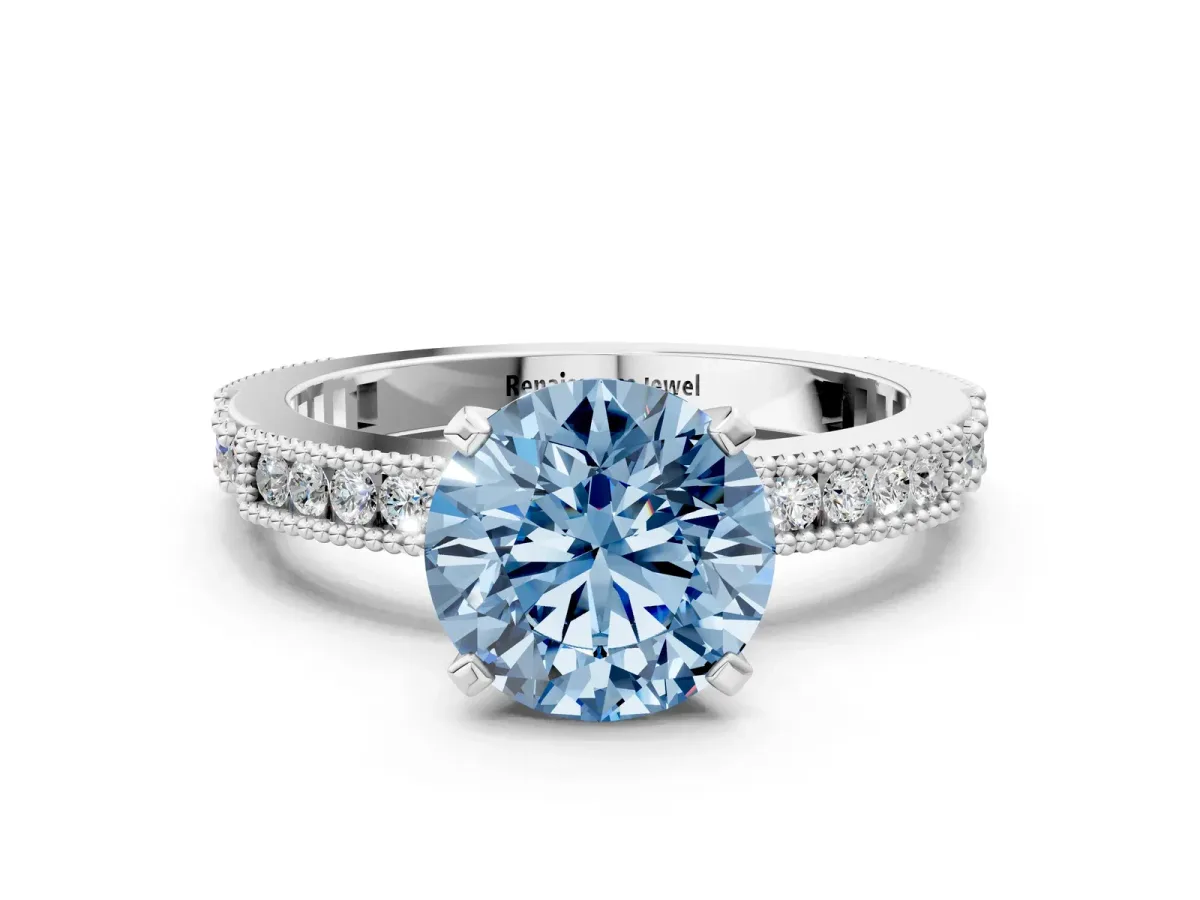 Fancy Blue Round Cut Solitaire with Pavé Band and Four-Prong Setting Silver