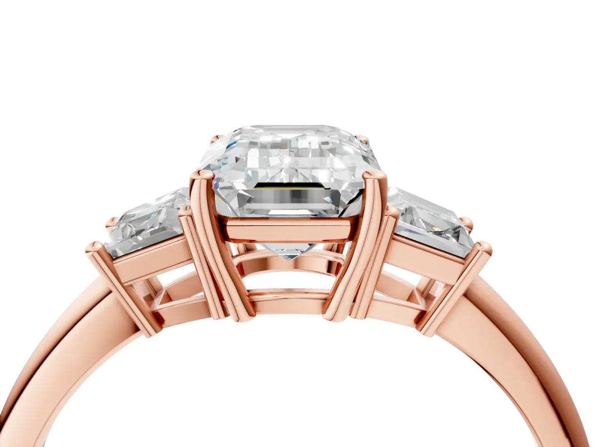 Emerald Cut Diamond Three-Stone Ring with Trapezoid Side Stones and Prong Setting Rose gold