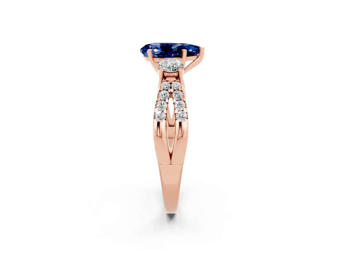 Pear Cut Blue Sapphire Three-Stone Ring with Pavé Split Shank and Four-Prong Setting Rose gold