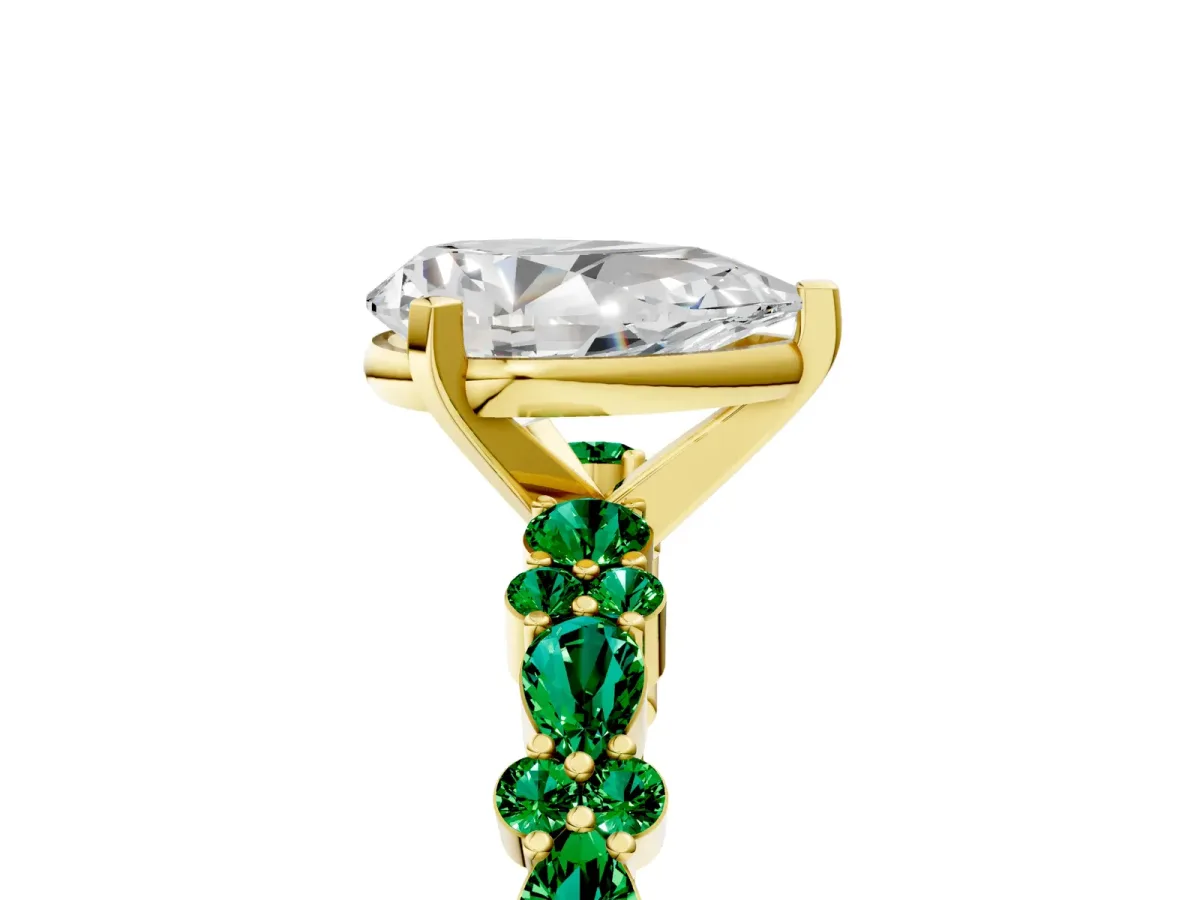 Pear Cut Diamond Side Stone Solitaire Ring with Round Emerald and Four-Prong Setting Yellow gold