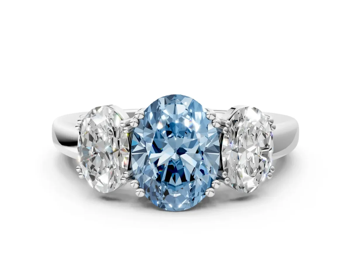 Fancy Blue Three-Stone Oval Cut Cut Diamond Ring with Channel Set Band and Four-Prong Setting Silver