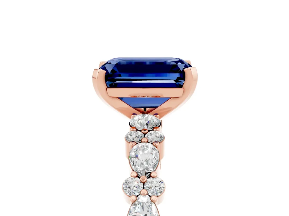Emerald Cut Blue Sapphire Side Stone Solitaire Ring with Round and Four-Prong Setting Rose gold
