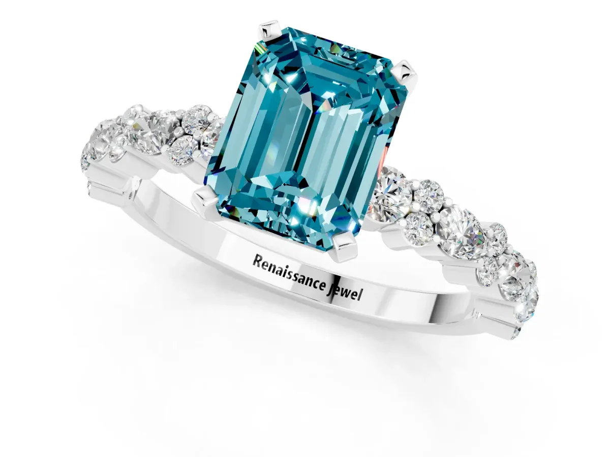 Emerald Cut Blue Topaz Side Stone Solitaire Ring with Round and Four-Prong Setting White gold
