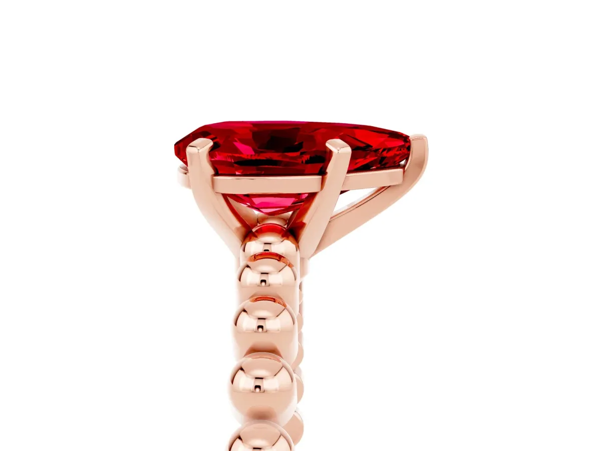 Pear Cut Ruby Solitaire Ring with Beaded Band and Prong Setting Rose gold