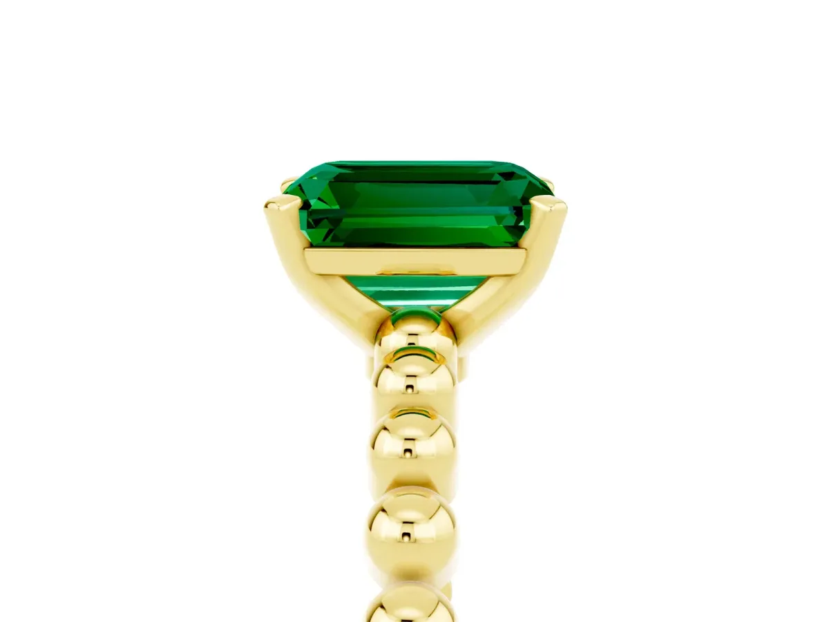 Emerald Cut Emerald Solitaire Ring with Beaded Band and Prong Setting Yellow gold