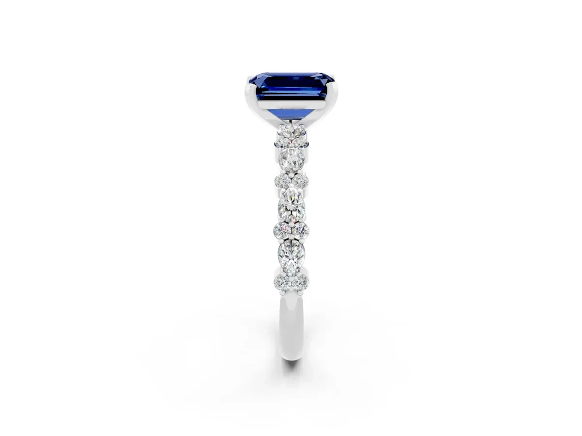 Emerald Cut Blue Sapphire Side Stone Solitaire Ring with Round and Four-Prong Setting Silver