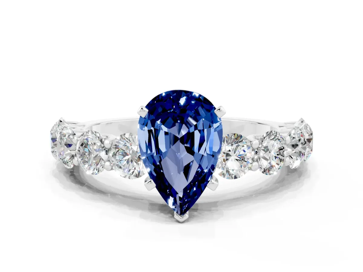 Pear Cut Blue Sapphire Prong Setting with Side Stones on a Pave Band Silver