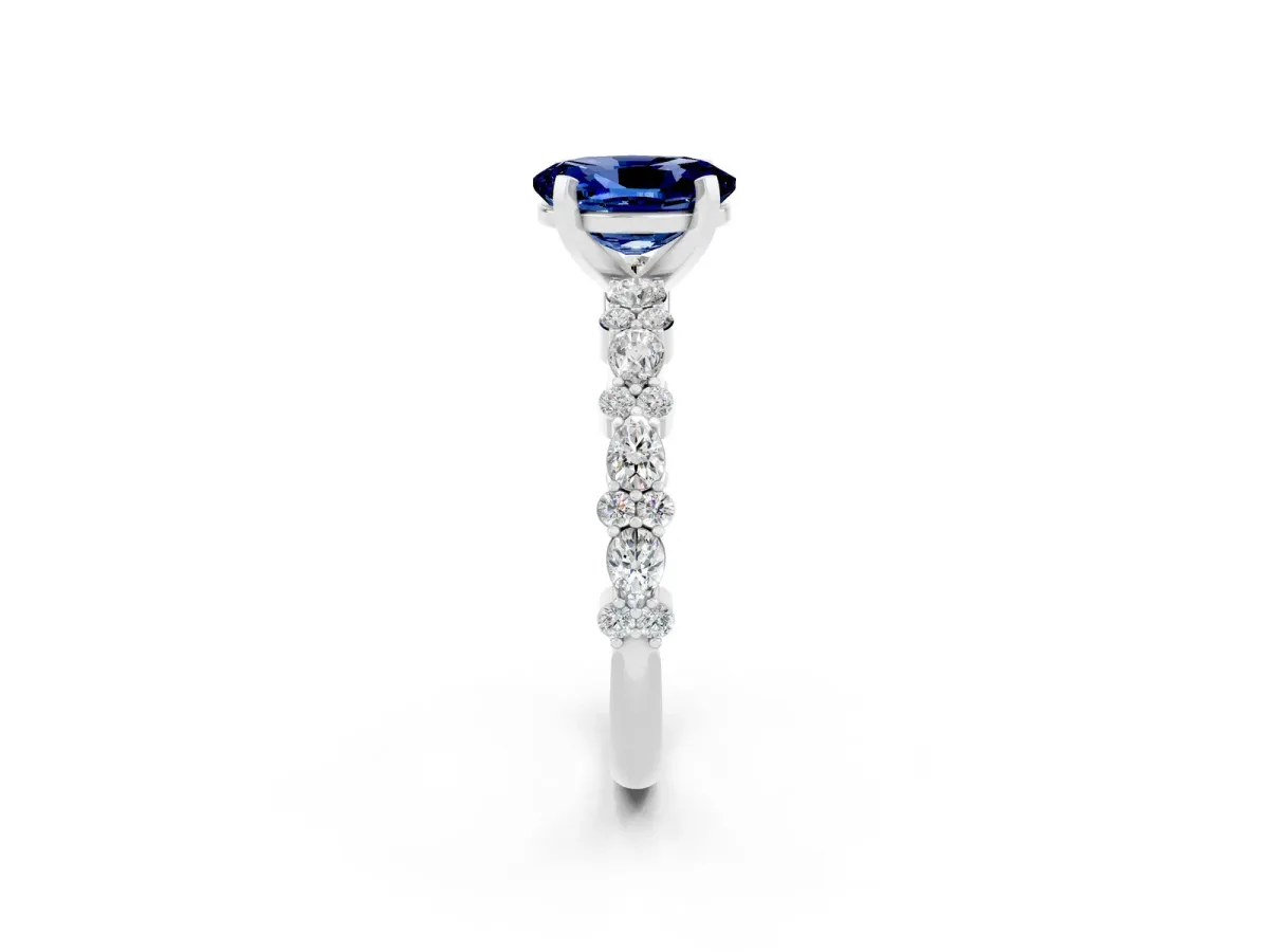 Oval Cut Blue Sapphire Side Stone Solitaire Ring with Round and Four-Prong Setting Platinum
