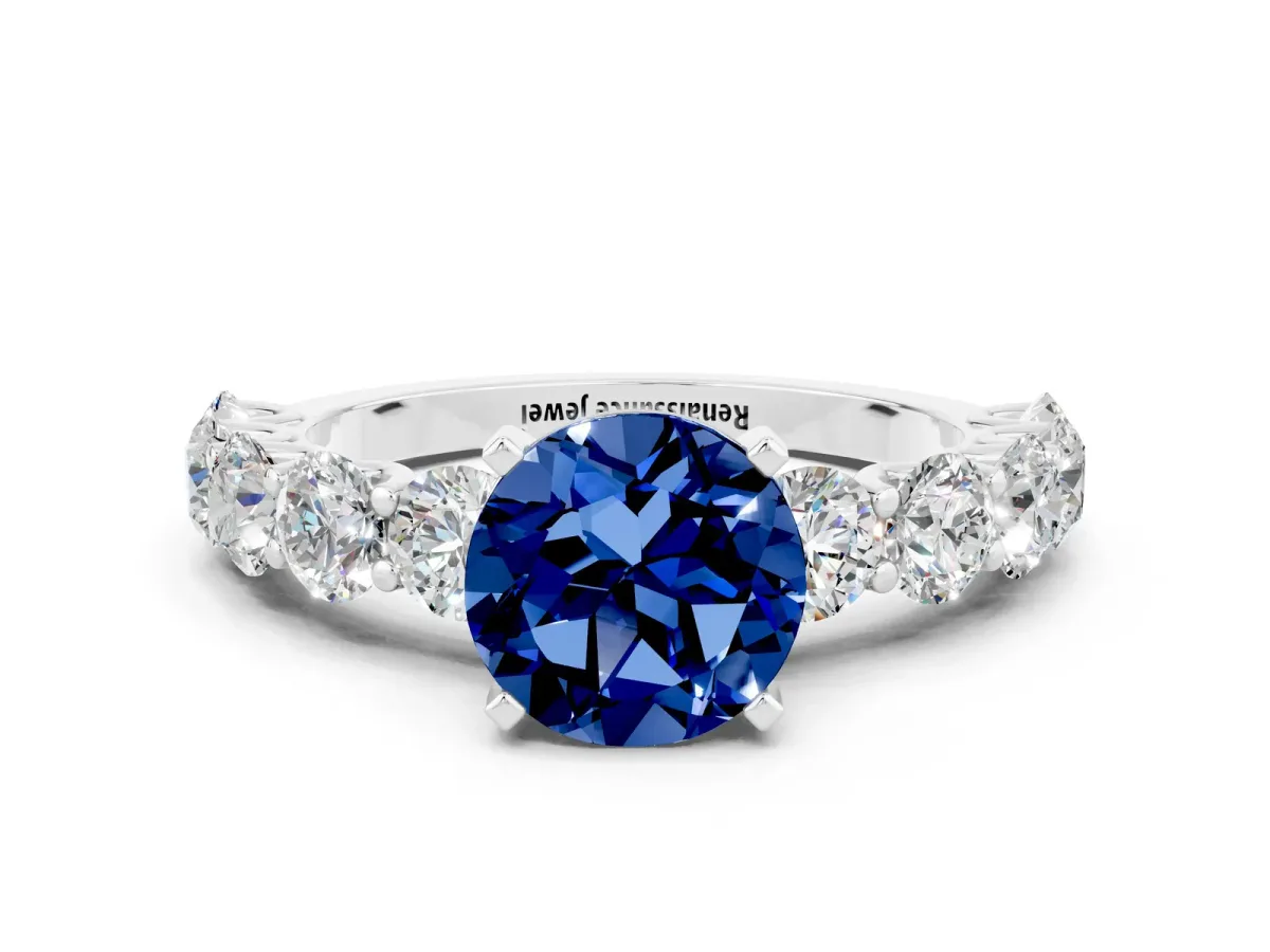 Round Cut Blue Sapphire Prong Setting with Side Stones on a Pave Band Platinum
