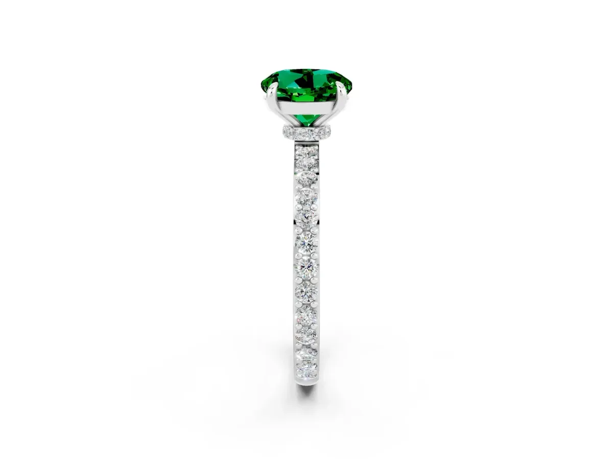 Round Cut Emerald Solitaire Engagement Ring with Pavé Band and Four-Prong Setting Silver