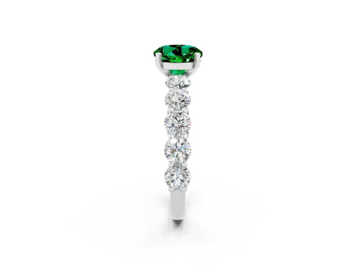 Round Cut Emerald Prong Setting with Side Stones on a Pave Band Silver