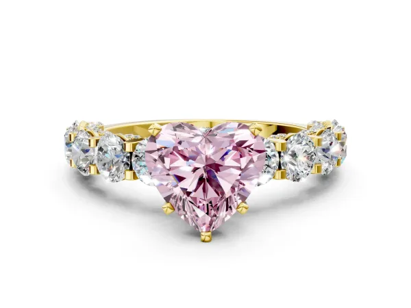 Fancy Pink Heart Cut Diamond Side Stone Engagement Ring with Four-Prong Setting Yellow gold