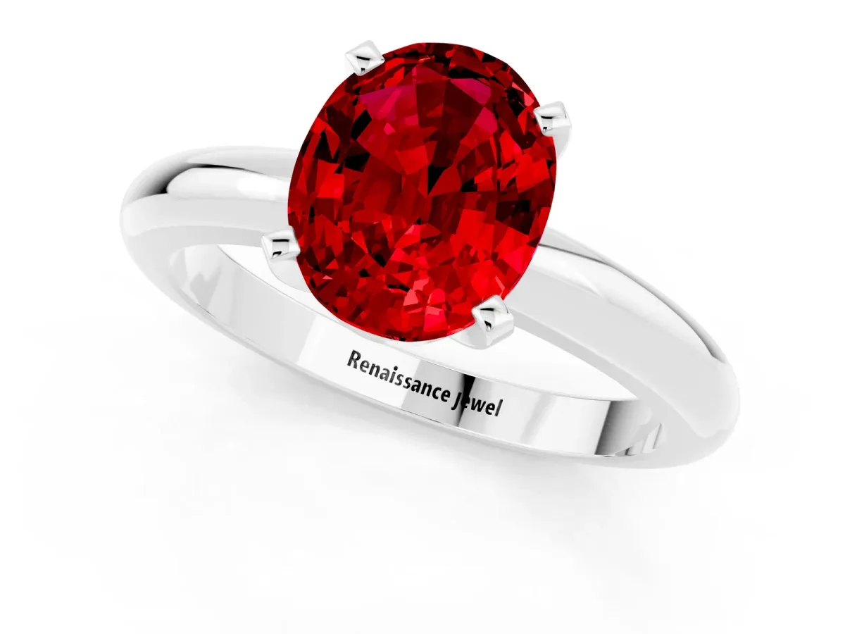 Oval Cut Ruby Solitaire Engagement Ring with Round Band and Four-Prong Setting Silver