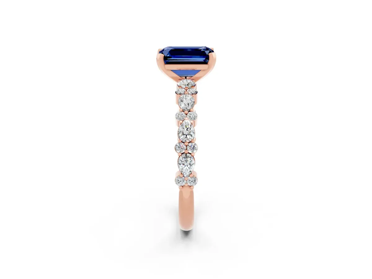 Emerald Cut Blue Sapphire Side Stone Solitaire Ring with Round and Four-Prong Setting Rose gold
