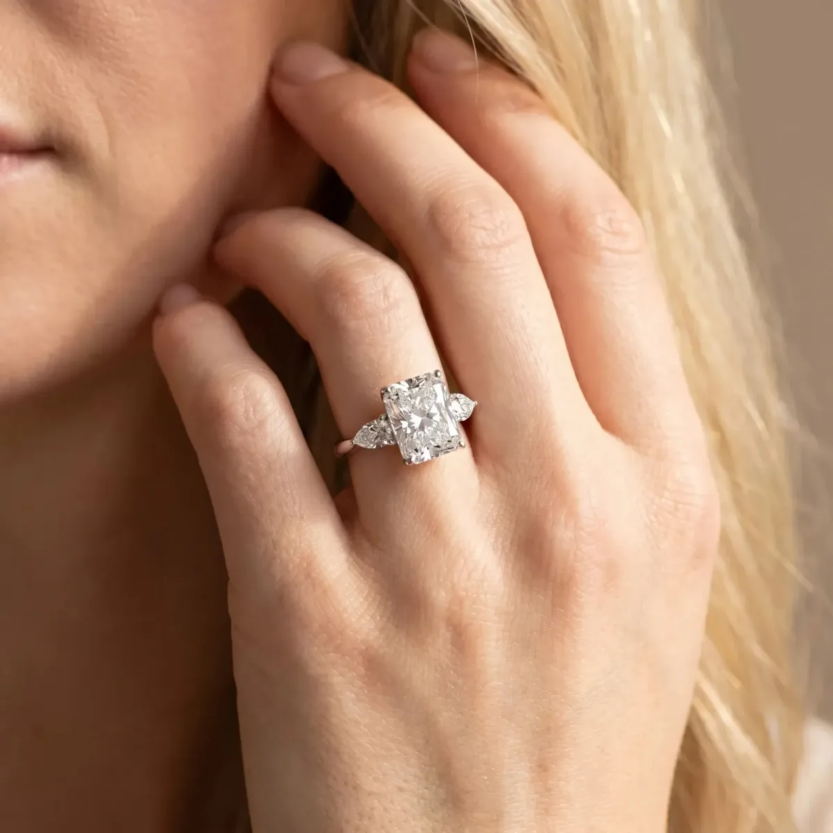 Three-Stone Radiant Cut Diamond Ring with Pear Side Stones in Four-Prong Setting Platinum