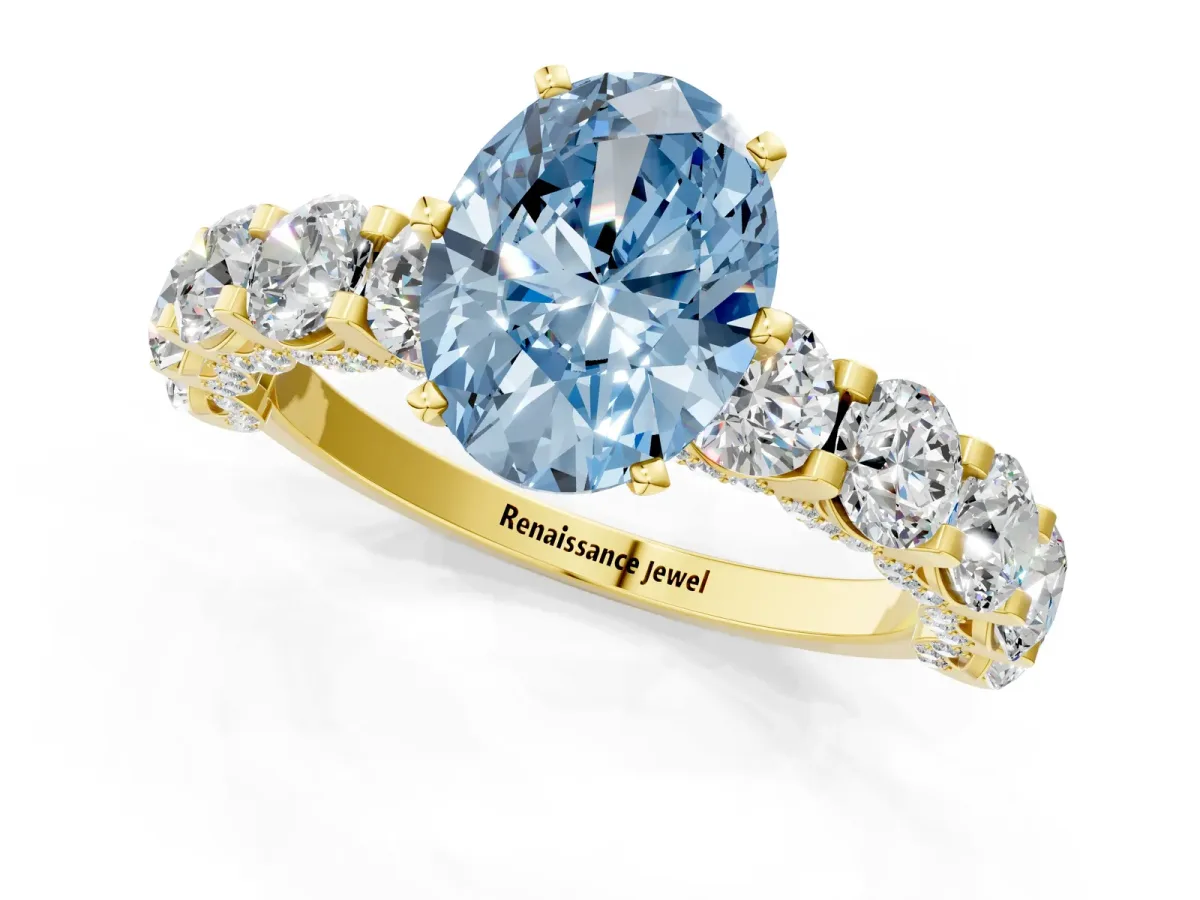 Fancy Blue Oval Cut Diamond Side Stone Engagement Ring with Four-Prong Setting Yellow gold