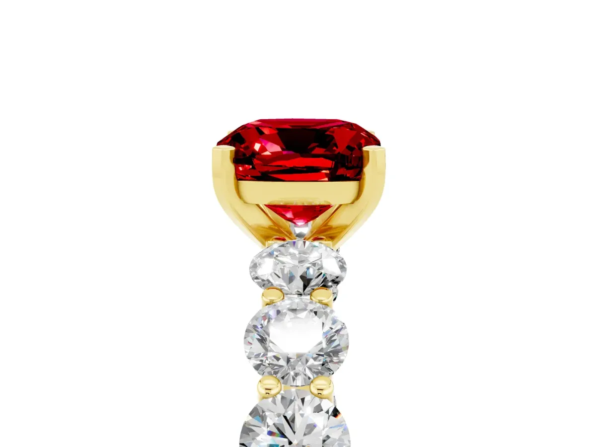 Cushion Cut Ruby Prong Setting with Side Stones on a Pave Band Yellow gold