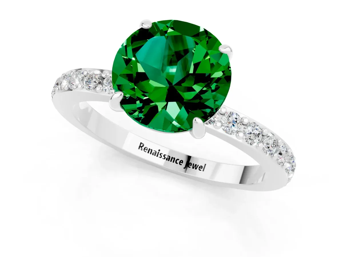 Round Cut Emerald Solitaire Engagement Ring with Pavé Band and Four-Prong Setting Silver