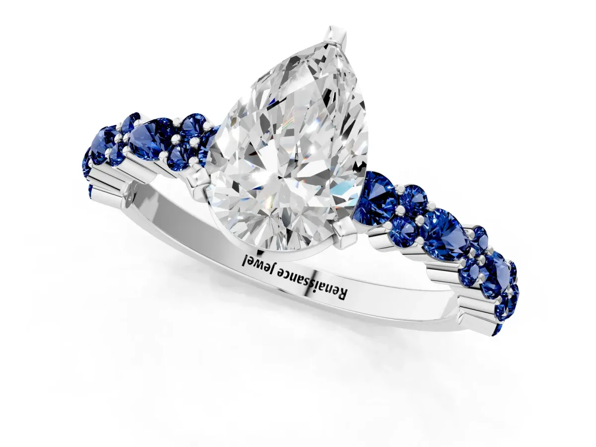 Pear Cut Diamond Side Stone Solitaire Ring with Round Blue Sapphire and Four-Prong Setting Silver