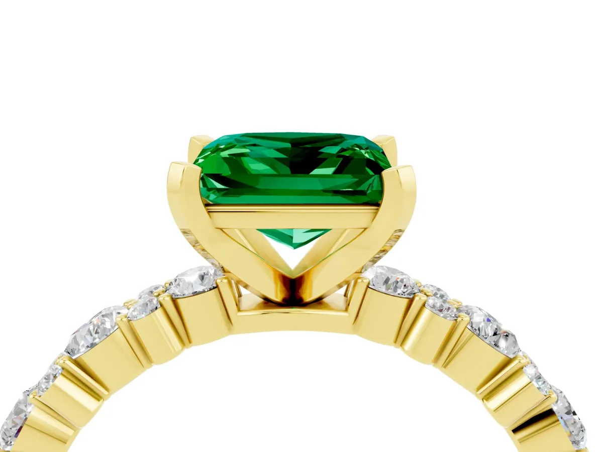 Princess Cut Emerald Side Stone Solitaire Ring with Round and Four-Prong Setting Yellow gold