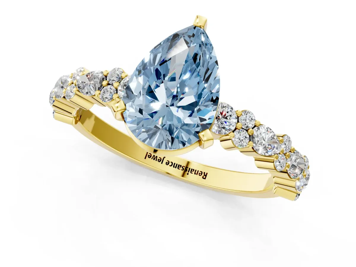 Fancy Blue Pear Cut Diamond Side Stone Solitaire Ring with Round and Four-Prong Setting Yellow gold