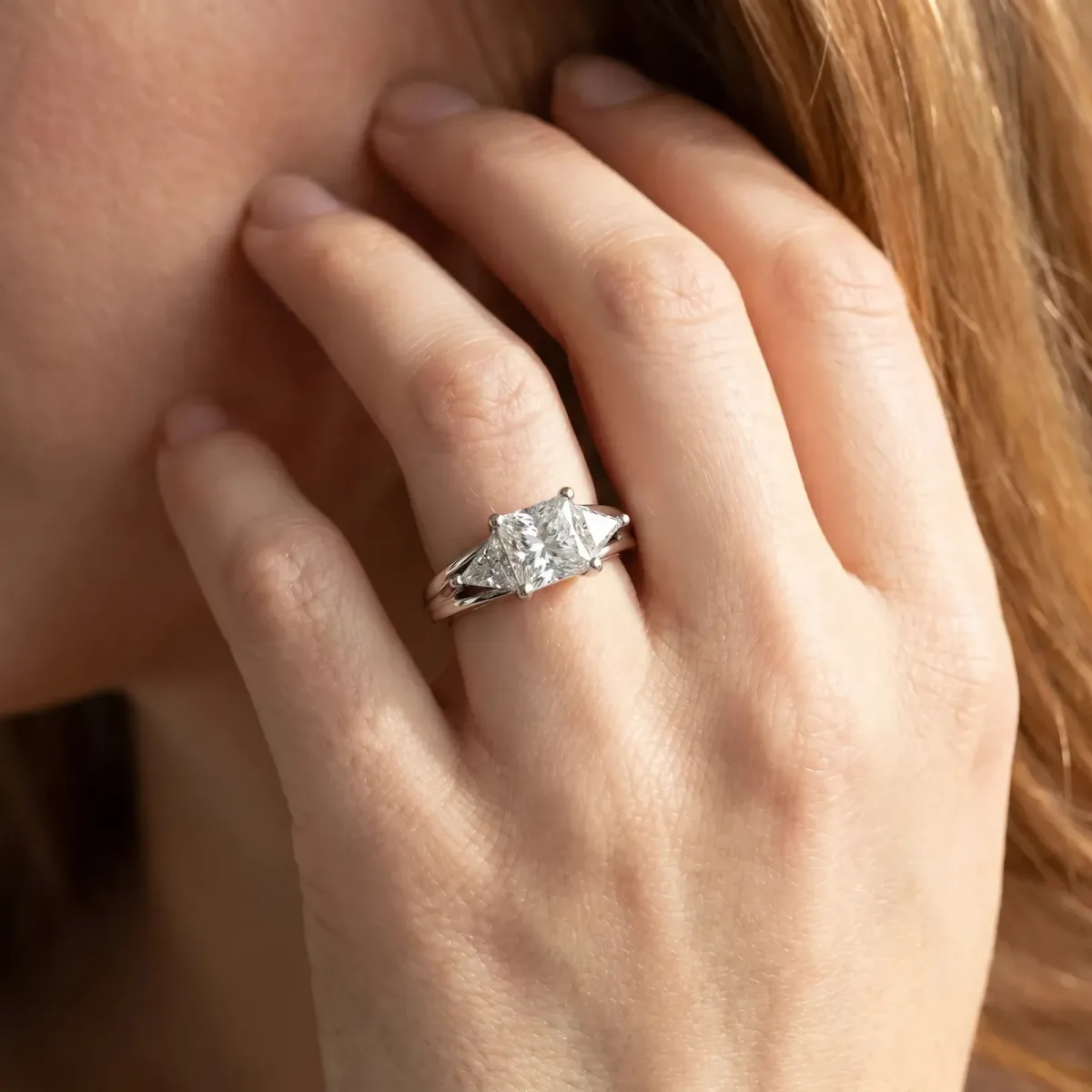 Three-Stone Princess Cut Cut Diamond Ring with Trillion Side Stones on a Split Shank Band Silver