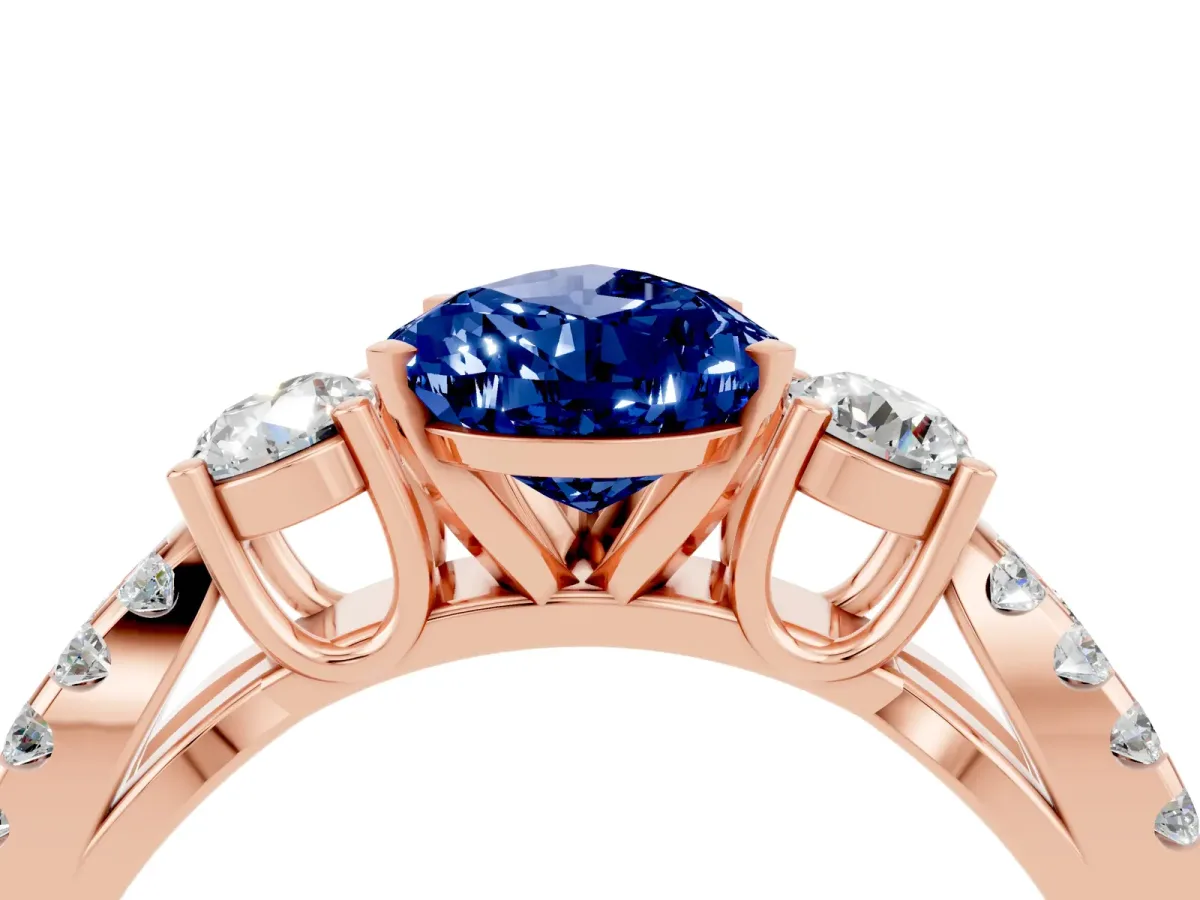 Pear Cut Blue Sapphire Three-Stone Ring with Pavé Split Shank and Four-Prong Setting Rose gold