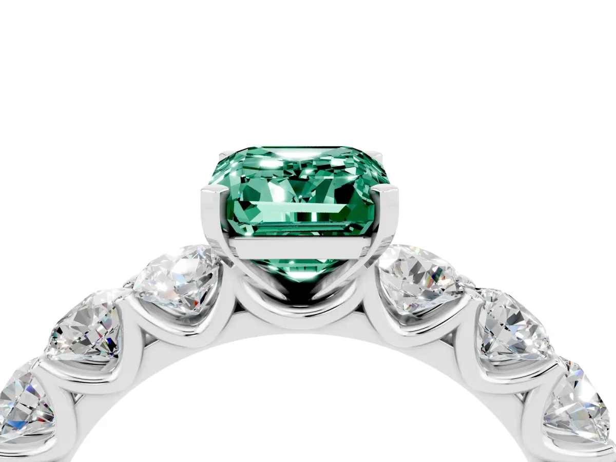 Emerald Cut Green Sapphire Prong Setting with Side Stones on a Pave Band Silver