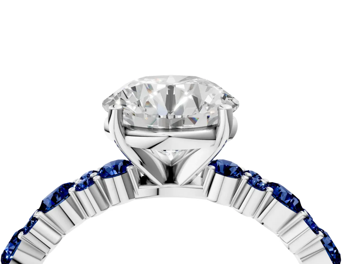 Round Cut Diamond Side Stone Solitaire Ring with Round Blue Sapphire and Four-Prong Setting Platinum